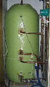 A hot water tank with a rigid jacket and a thermostat.
